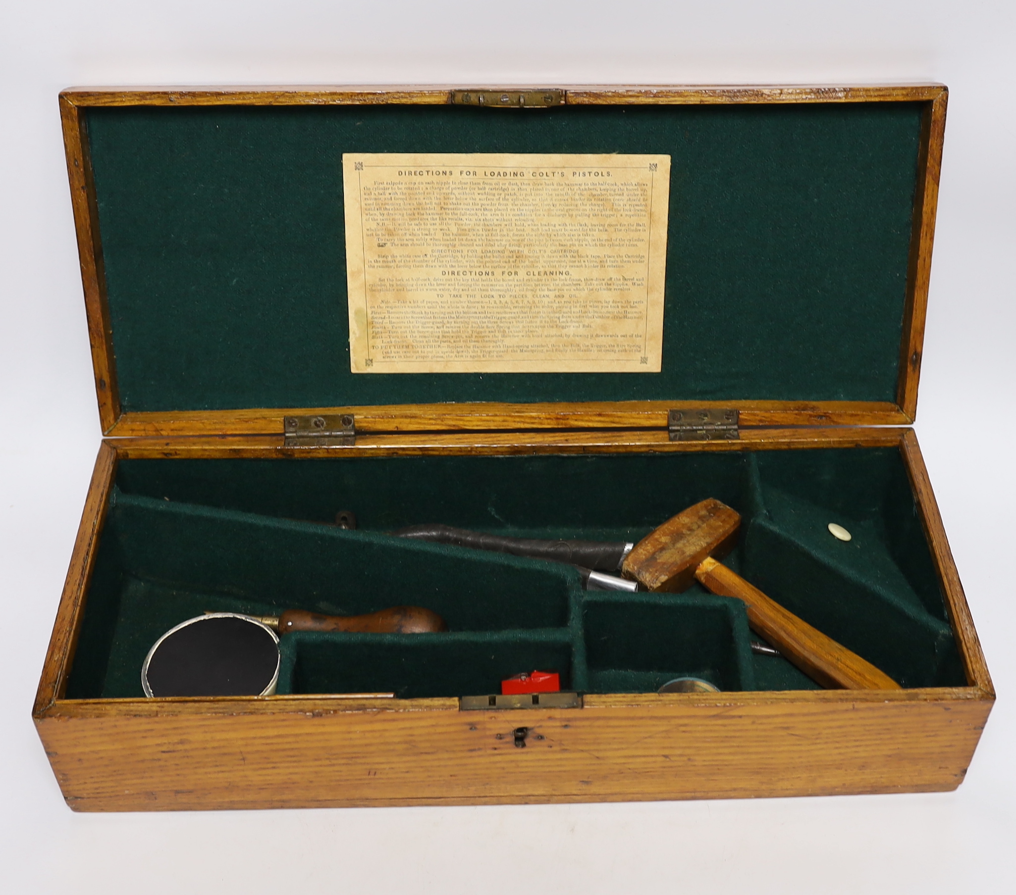 An oak Colt pistol box, felt lined compartments containing a few tools including a bullet mould, label for directions to the inside of the lid, dimensions 45.5 x 18 x 11.5cm